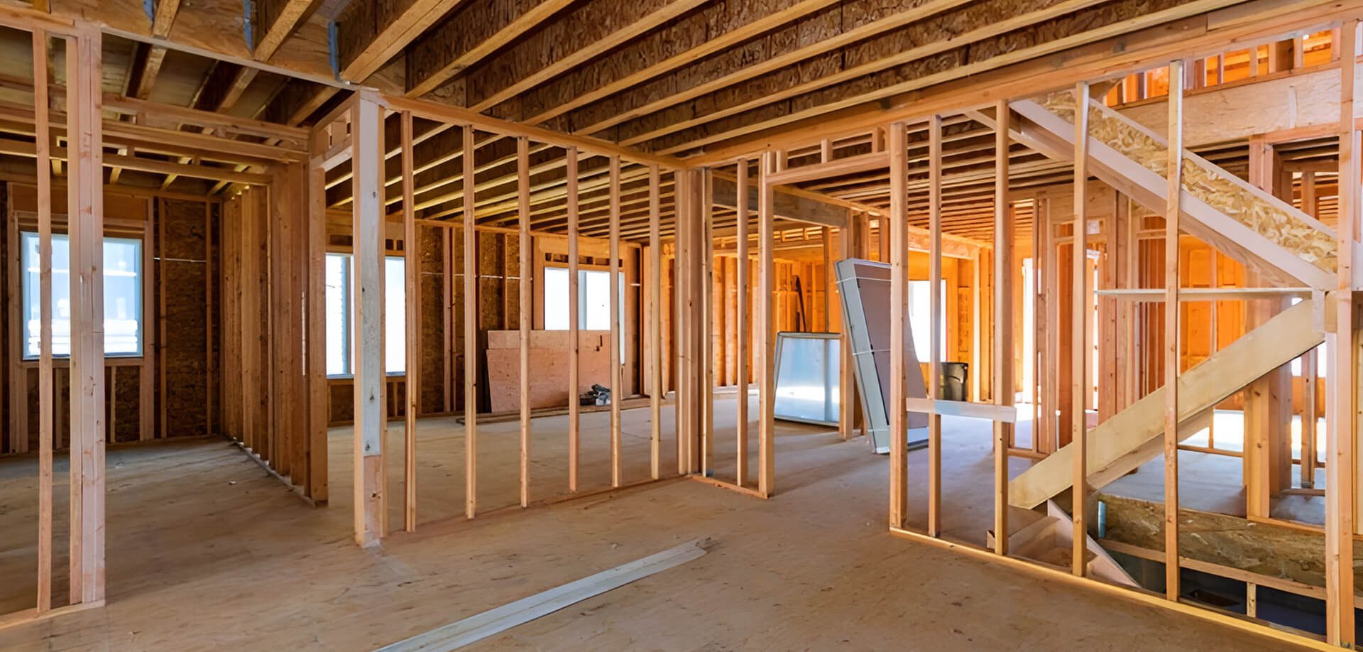 A room with wood framing and wooden floors.